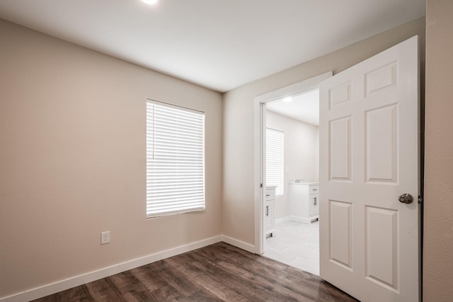 308 Greenbriar Dr, Baytown, TX 77520 - spare room featuring dark wood-style flooring and baseboards