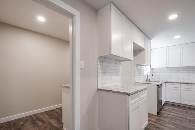 308 Greenbriar Dr, Baytown, TX 77520 - kitchen with light stone countertops, dark wood-type flooring, a sink, recessed lighting, and decorative backsplash