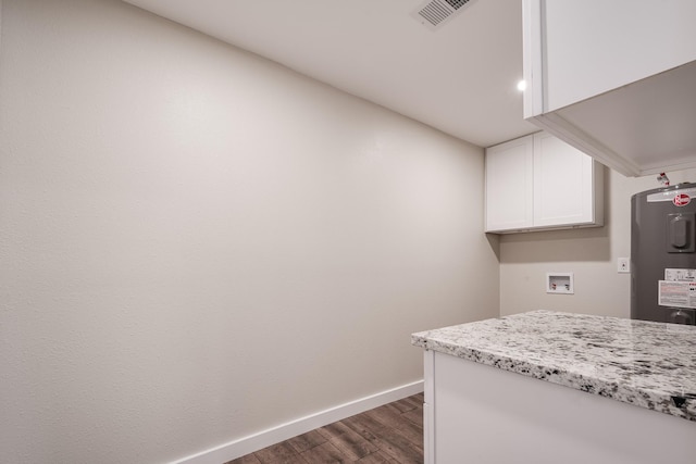 308 Greenbriar Dr, Baytown, TX 77520 - laundry area with dark wood-style flooring, electric water heater, baseboards, cabinet space, and washer hookup