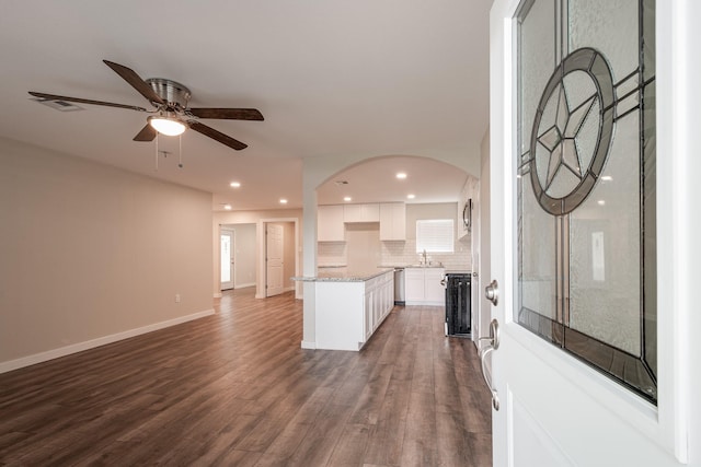308 Greenbriar Dr, Baytown, TX 77520 - kitchen with open floor plan, stainless steel dishwasher, white cabinetry, dark wood finished floors, and tasteful backsplash
