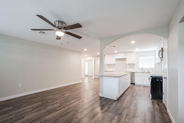 308 Greenbriar Dr, Baytown, TX 77520 - kitchen with a sink, ceiling fan, open floor plan, dark wood-type flooring, and arched walkways