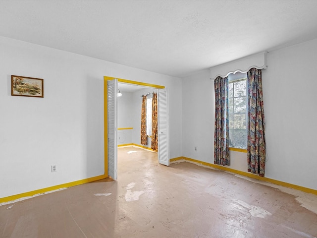 21326 Four Oaks Dr, Houston, TX 77073 - unfurnished room featuring baseboards and concrete floors