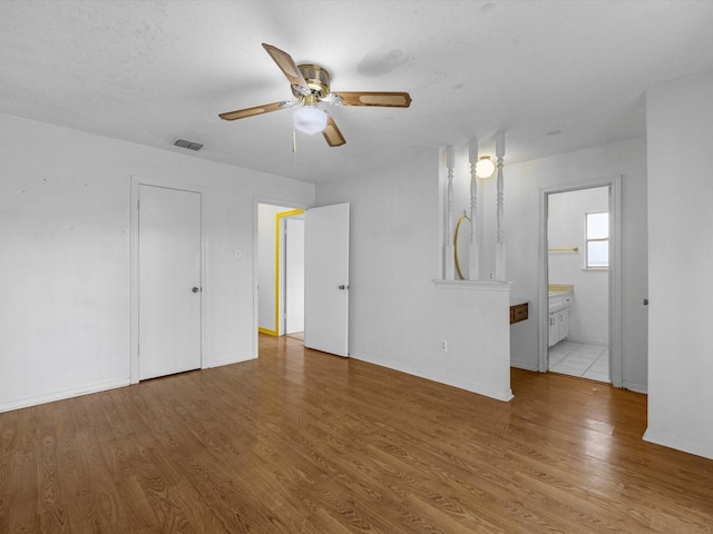 21326 Four Oaks Dr, Houston, TX 77073 - unfurnished living room featuring a ceiling fan, wood finished floors, and baseboards