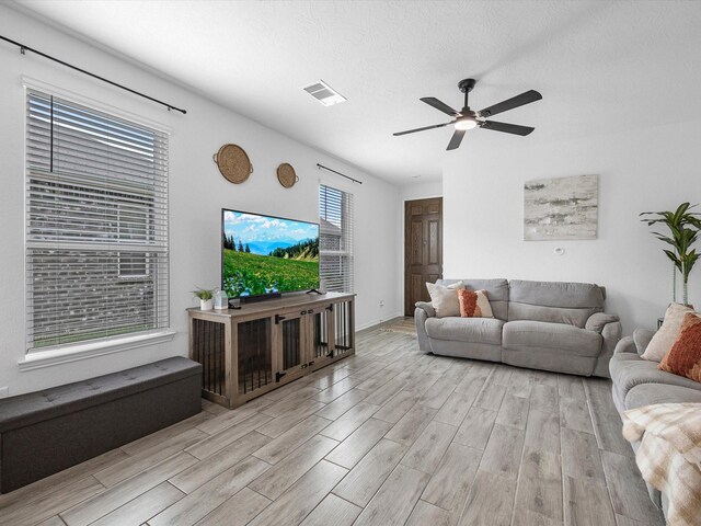 15618 Cliffside Arbor Ln, Houston, TX 77044 - living room featuring light wood-style floors, a ceiling fan, and baseboards