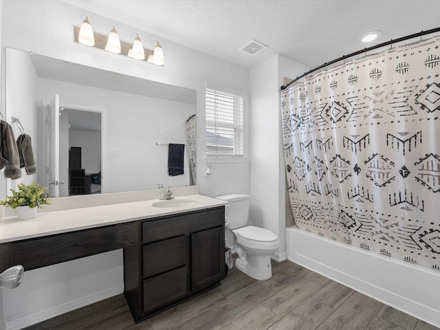 15618 Cliffside Arbor Ln, Houston, TX 77044 - full bath with wood finished floors, vanity, shower / tub combo, toilet, and a textured ceiling