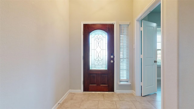 5434 Wildbrush Dr, Richmond, TX 77407 - entrance foyer with light tile patterned floors, plenty of natural light, and baseboards