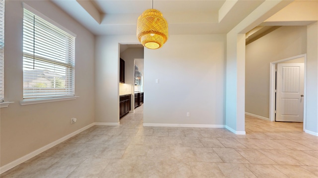5434 Wildbrush Dr, Richmond, TX 77407 - unfurnished room with a tray ceiling, light tile patterned floors, and baseboards