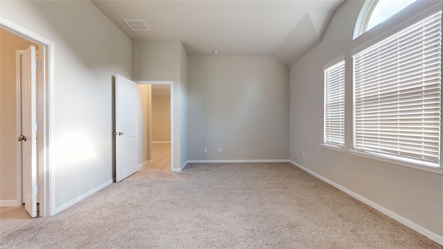 5434 Wildbrush Dr, Richmond, TX 77407 - unfurnished bedroom with carpet flooring, multiple windows, baseboards, and lofted ceiling