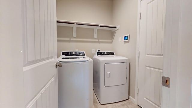 5434 Wildbrush Dr, Richmond, TX 77407 - laundry room featuring separate washer and dryer and light tile patterned floors