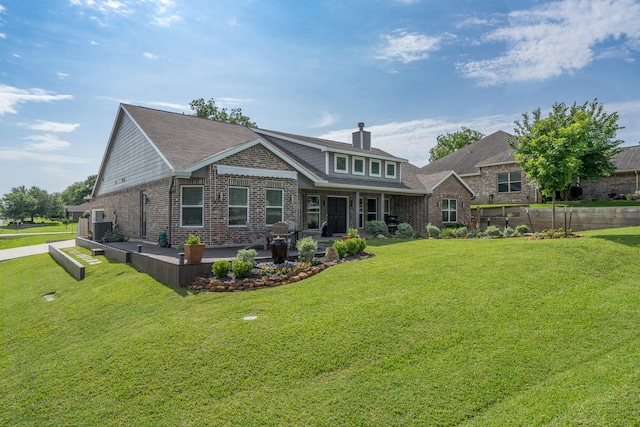 454 Cape Conroe Dr, Montgomery, TX 77356 - rear view of house featuring brick siding, a patio area, a yard, and a chimney