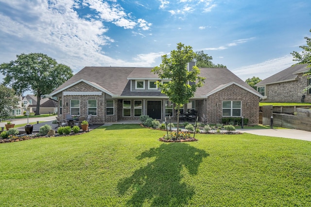 454 Cape Conroe Dr, Montgomery, TX 77356 - view of front of home with brick siding, roof with shingles, and a patio area