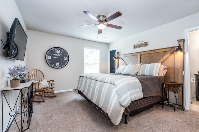 454 Cape Conroe Dr, Montgomery, TX 77356 - carpeted bedroom with baseboards, ceiling fan, and ensuite bath