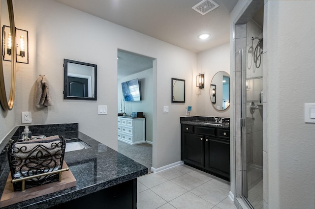 454 Cape Conroe Dr, Montgomery, TX 77356 - bathroom with two vanities, a stall shower, tile patterned flooring, and baseboards