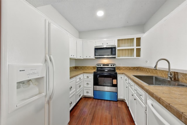 3126 Windchase Blvd Unit 421, Houston, TX 77082 - kitchen featuring white appliances, a sink, white cabinets, and dark wood-style floors