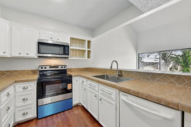 3126 Windchase Blvd Unit 421, Houston, TX 77082 - kitchen featuring appliances with stainless steel finishes, a sink, white cabinets, and dark wood-type flooring