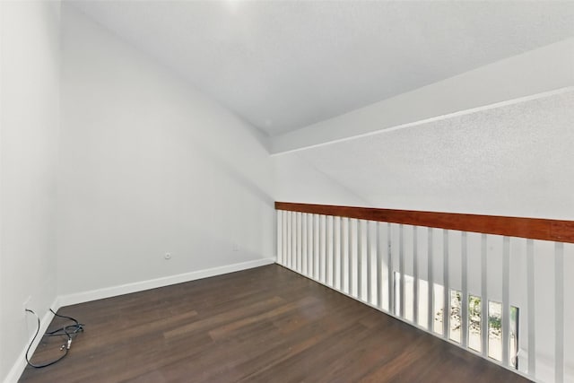 3126 Windchase Blvd Unit 421, Houston, TX 77082 - bonus room with wood finished floors, baseboards, and lofted ceiling