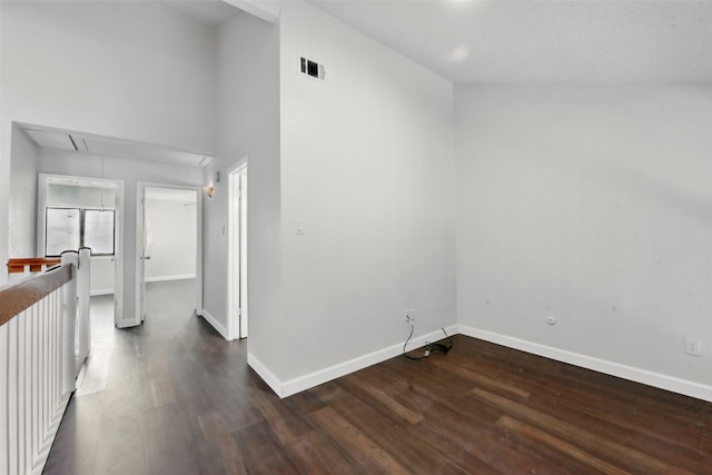 3126 Windchase Blvd Unit 421, Houston, TX 77082 - spare room featuring attic access, dark wood finished floors, baseboards, and a high ceiling