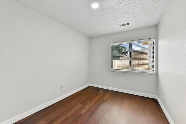 3126 Windchase Blvd Unit 421, Houston, TX 77082 - spare room with dark wood-type flooring, baseboards, and a textured ceiling