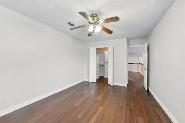 3126 Windchase Blvd Unit 421, Houston, TX 77082 - unfurnished bedroom featuring wood finished floors, a textured ceiling, baseboards, a closet, and a ceiling fan