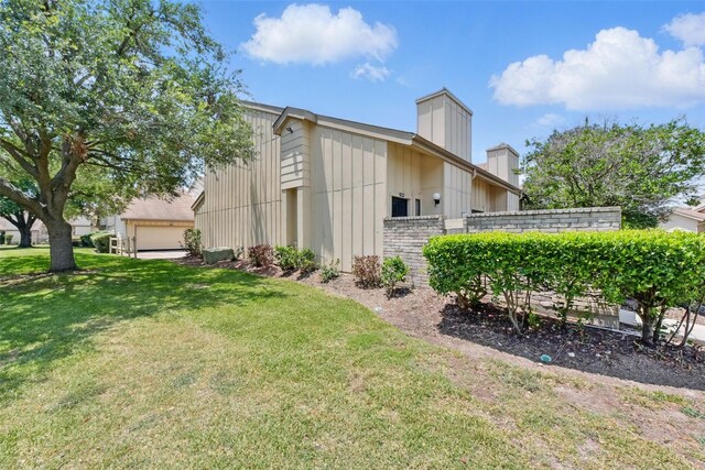 3126 Windchase Blvd Unit 421, Houston, TX 77082 - view of side of home with a chimney and a yard