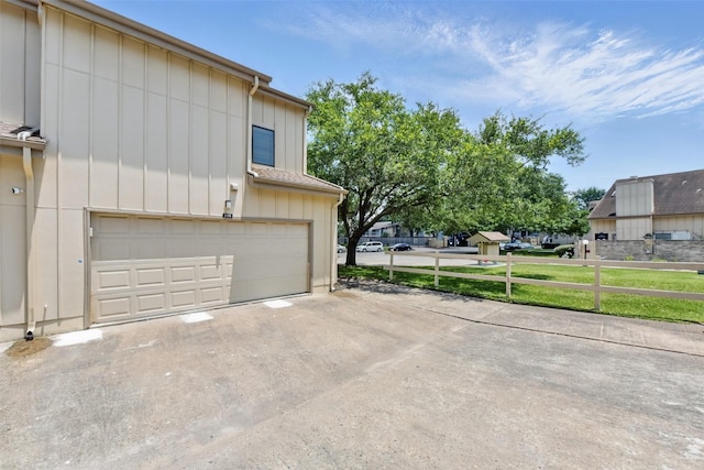 3126 Windchase Blvd Unit 421, Houston, TX 77082 - view of home's exterior with an attached garage, driveway, and board and batten siding