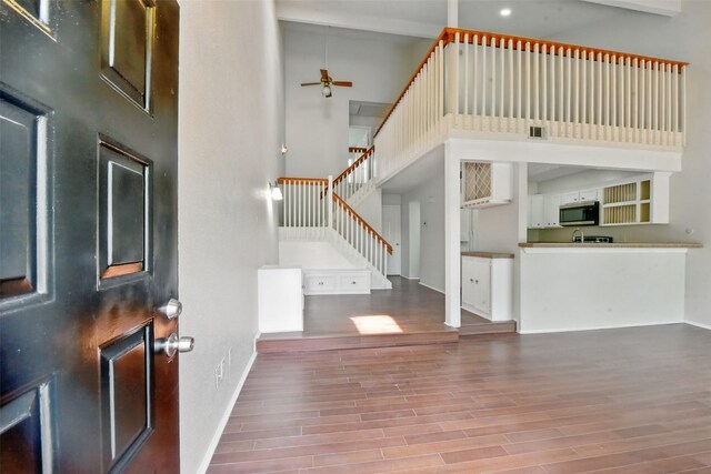 3126 Windchase Blvd Unit 421, Houston, TX 77082 - entrance foyer with a towering ceiling, wood finished floors, ceiling fan, stairway, and baseboards