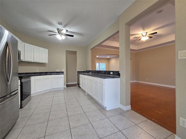 1944 Hillcroft, Prairie View, TX 77445 - kitchen featuring appliances with stainless steel finishes, ceiling fan, light tile patterned floors, white cabinets, and dark countertops