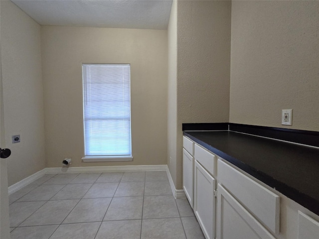 1944 Hillcroft, Prairie View, TX 77445 - washroom with electric dryer hookup, light tile patterned floors, and baseboards