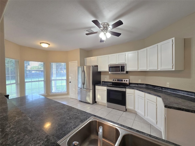 1944 Hillcroft, Prairie View, TX 77445 - kitchen featuring stainless steel appliances, white cabinetry, and ceiling fan