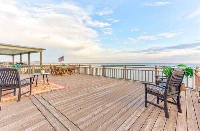 423 Hana Dr, Tiki Island, TX 77554 - wooden deck featuring outdoor dining space and a water view