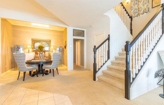 423 Hana Dr, Tiki Island, TX 77554 - carpeted dining area featuring stairway, tile patterned flooring, and baseboards