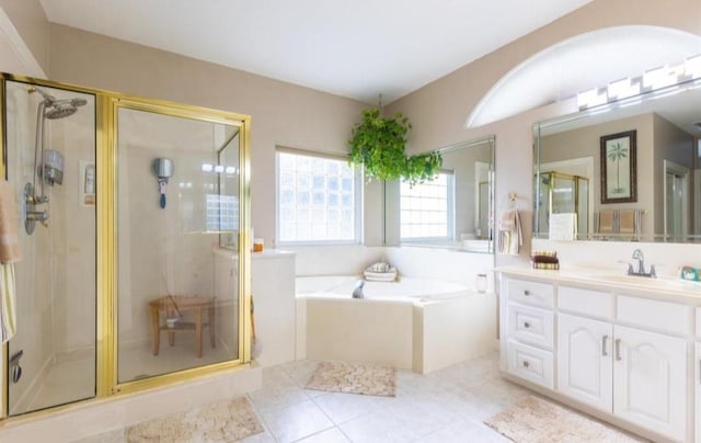 423 Hana Dr, Tiki Island, TX 77554 - bathroom featuring a bath, vanity, and a shower stall