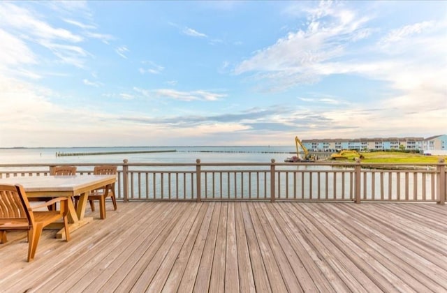 423 Hana Dr, Tiki Island, TX 77554 - wooden deck with a water view and outdoor dining area