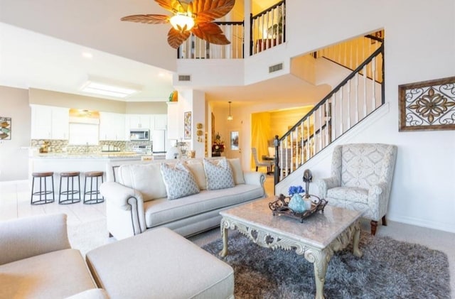 423 Hana Dr, Tiki Island, TX 77554 - living area with stairs, ceiling fan, and baseboards