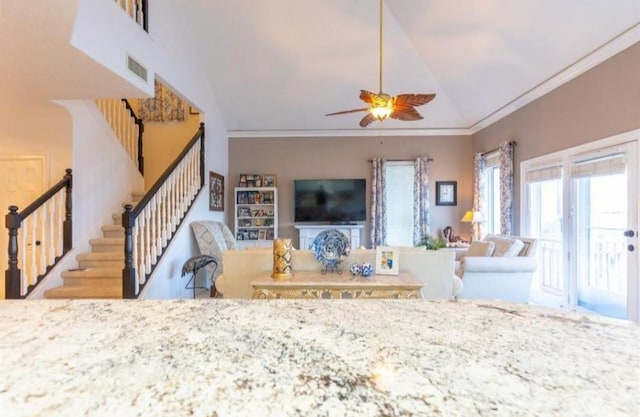423 Hana Dr, Tiki Island, TX 77554 - living area with stairs, ornamental molding, a ceiling fan, and vaulted ceiling