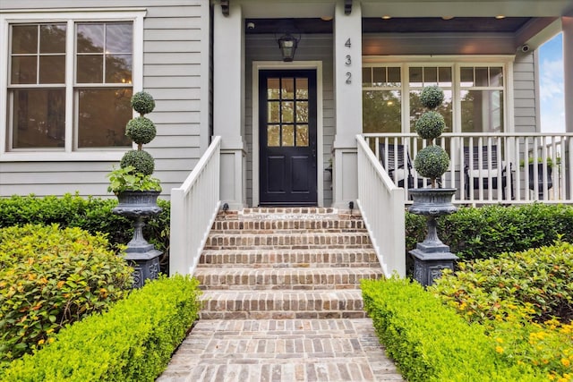 432 Marshall St, Houston, TX 77006 - view of exterior entry featuring covered porch and a surveillance system