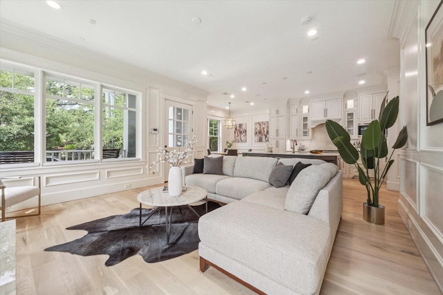 432 Marshall St, Houston, TX 77006 - living room with light wood-style floors, recessed lighting, ornamental molding, and a decorative wall