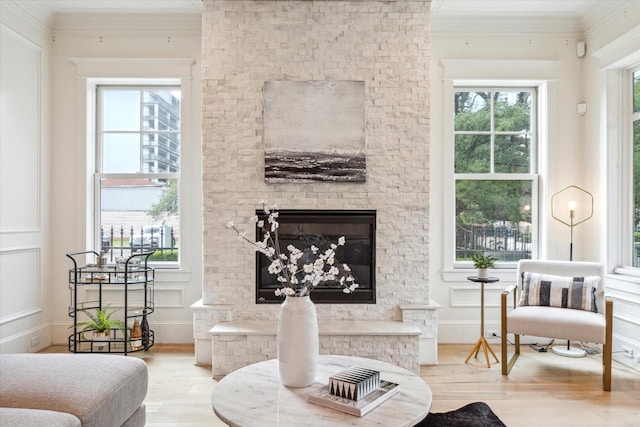 432 Marshall St, Houston, TX 77006 - living room featuring wood finished floors, plenty of natural light, ornamental molding, and a glass covered fireplace