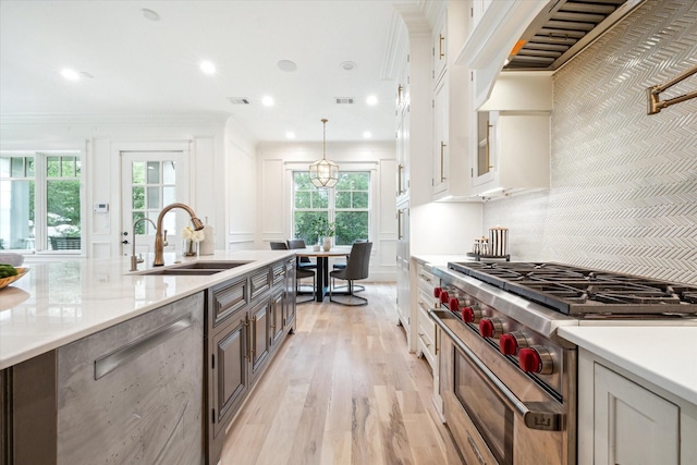 432 Marshall St, Houston, TX 77006 - kitchen featuring high end stove, a sink, premium range hood, plenty of natural light, and recessed lighting