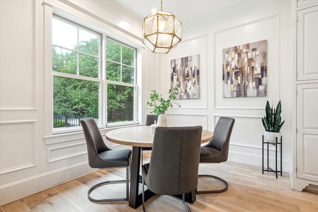 432 Marshall St, Houston, TX 77006 - dining room featuring a decorative wall, a chandelier, crown molding, and light wood-type flooring