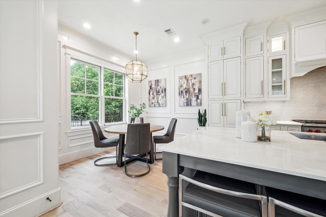 432 Marshall St, Houston, TX 77006 - dining space featuring light wood finished floors and crown molding