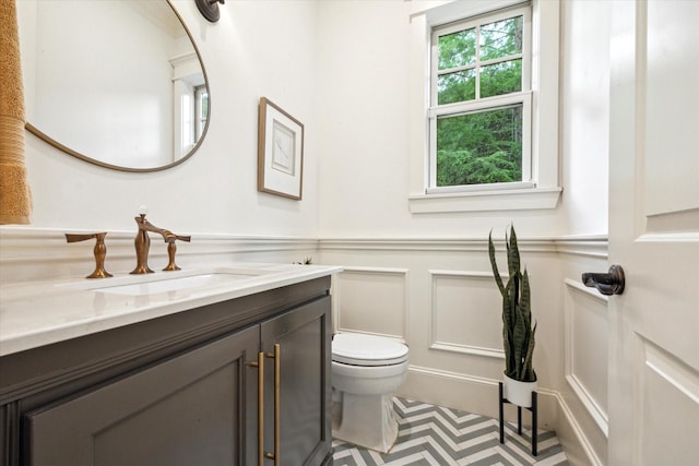 432 Marshall St, Houston, TX 77006 - bathroom with vanity, toilet, a decorative wall, and a wainscoted wall