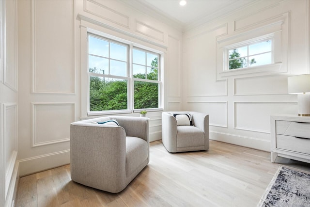432 Marshall St, Houston, TX 77006 - living area featuring a decorative wall, crown molding, and light wood-type flooring