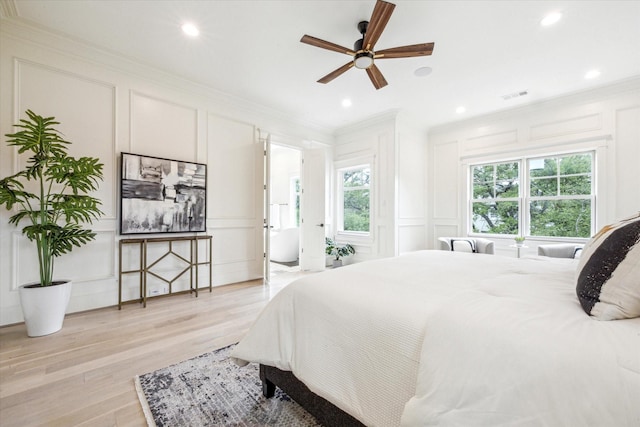 432 Marshall St, Houston, TX 77006 - bedroom featuring a decorative wall, crown molding, light wood-type flooring, and recessed lighting