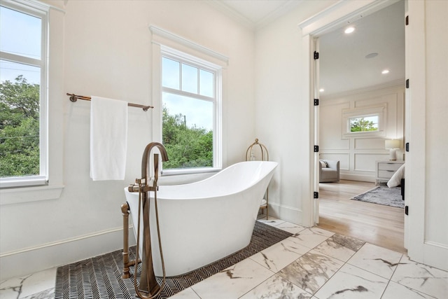 432 Marshall St, Houston, TX 77006 - bathroom with healthy amount of natural light, marble finish floors, ornamental molding, a soaking tub, and recessed lighting
