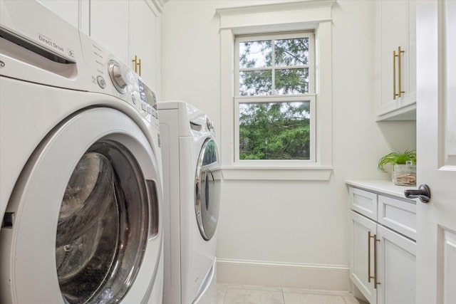 432 Marshall St, Houston, TX 77006 - laundry area with separate washer and dryer, cabinet space, baseboards, and light tile patterned floors