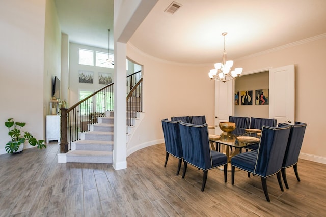 9411 Plaza Point Dr, Missouri City, TX 77459 - dining room with a chandelier, stairway, wood finished floors, baseboards, and crown molding