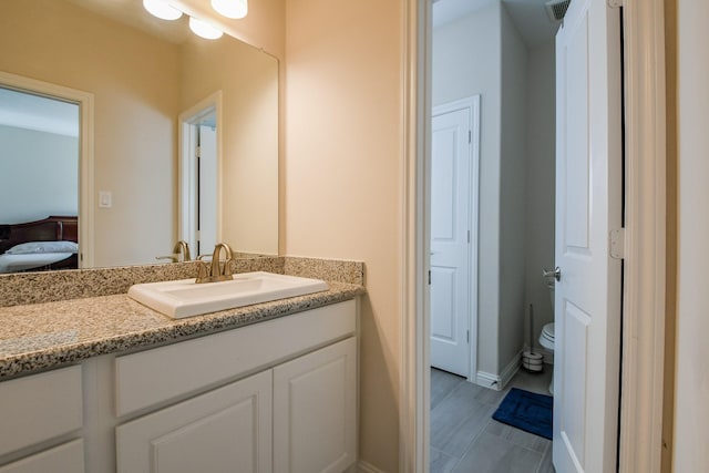 9411 Plaza Point Dr, Missouri City, TX 77459 - ensuite bathroom featuring vanity, toilet, and baseboards