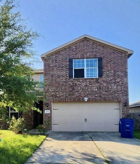 1015 Amaryllis Rd, Baytown, TX 77521 - view of side of property featuring brick siding, a garage, and concrete driveway