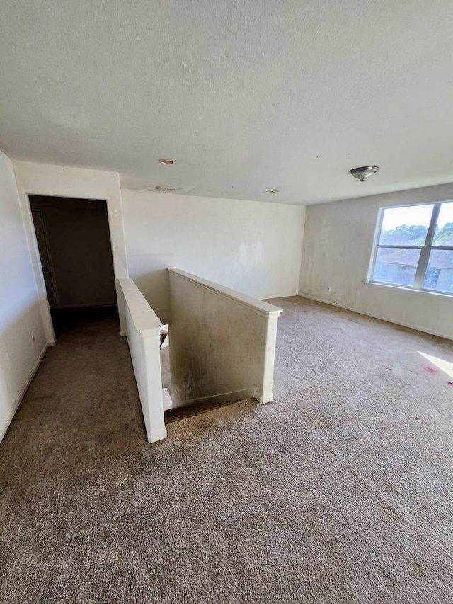 1015 Amaryllis Rd, Baytown, TX 77521 - carpeted empty room with a textured ceiling